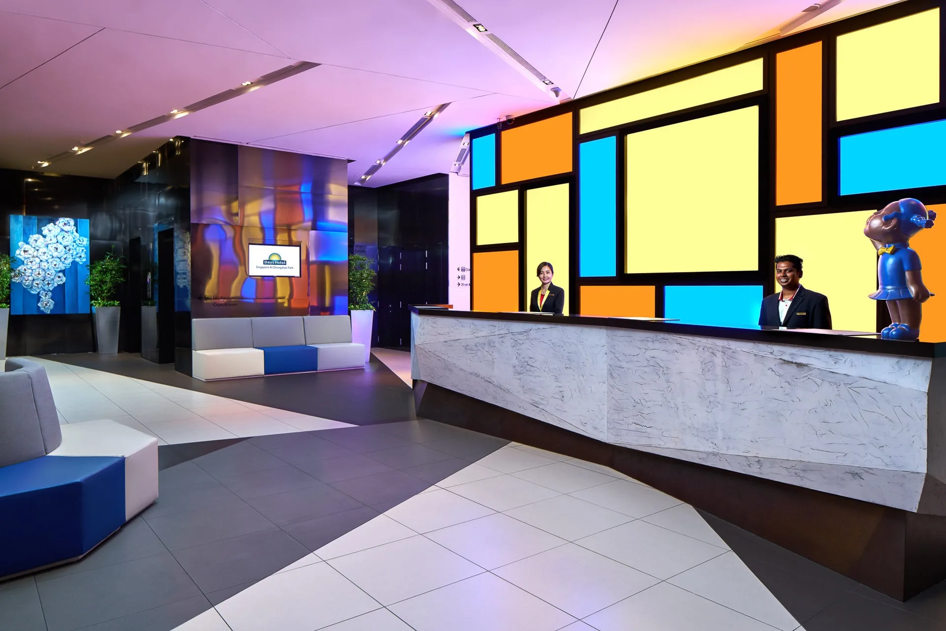 Lobby with Mondrian backlit wall, blue seating and purple ambient ceiling