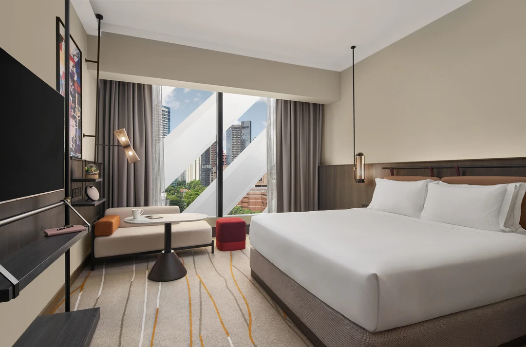 Deluxe premiere king room with open sheers and panoramic city views