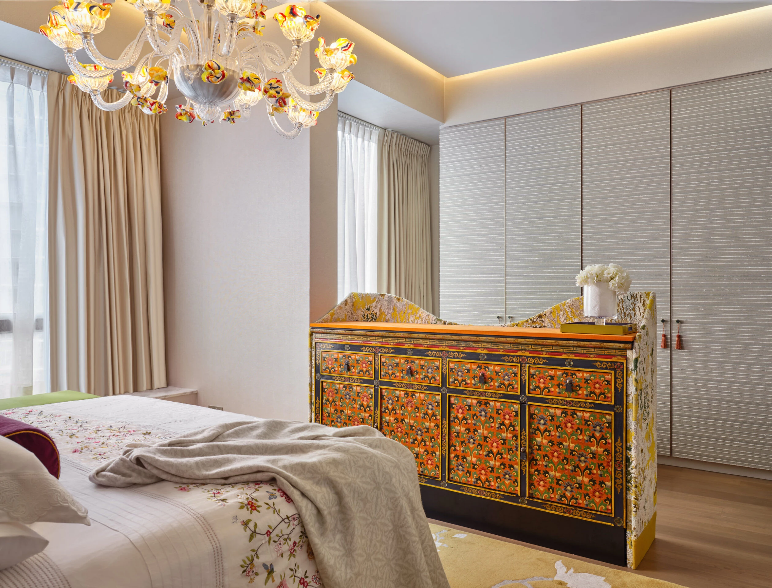Bedroom with ornate TV console at foot of bed in lowered position