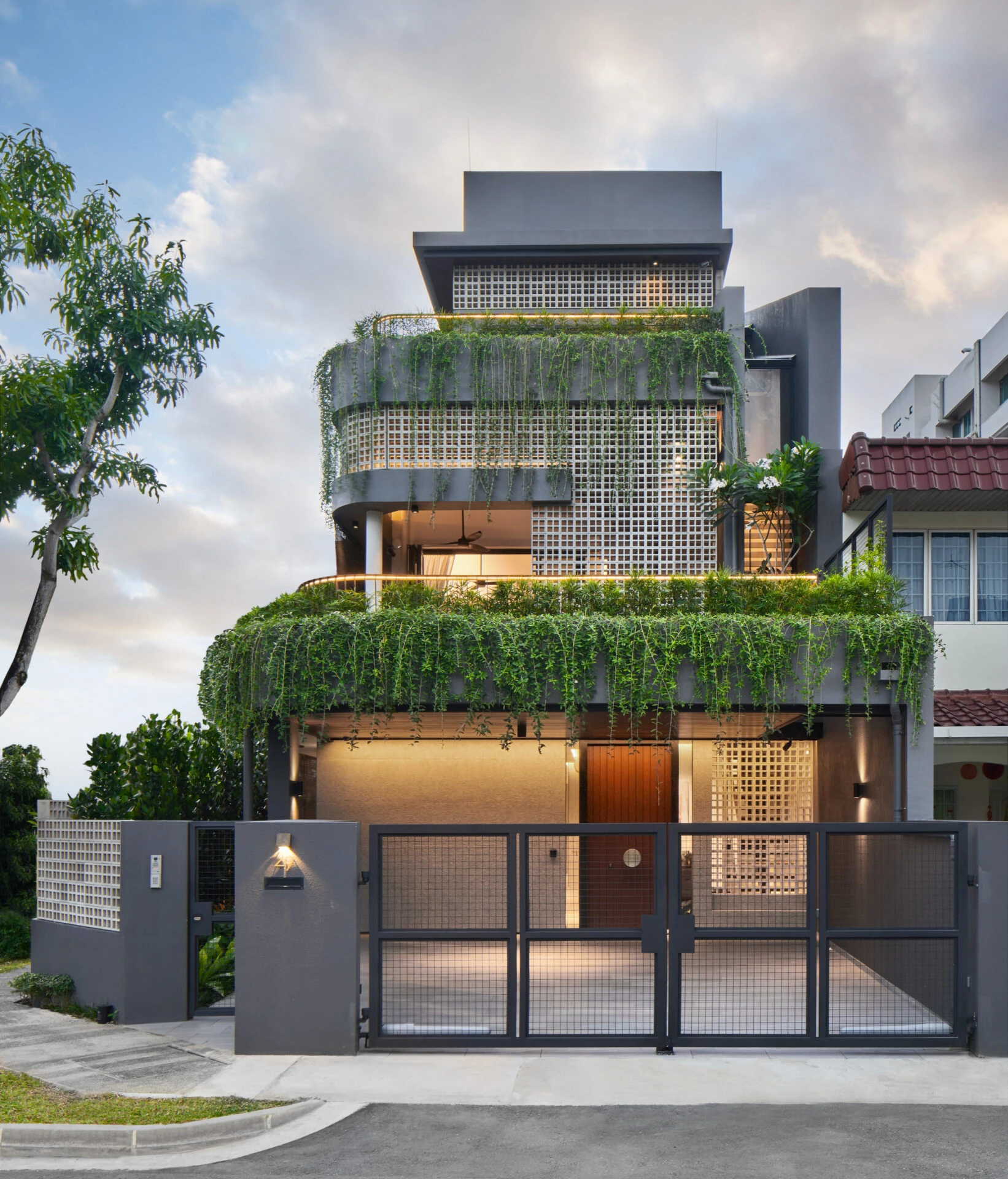 Contemporary residential facade with greenery.