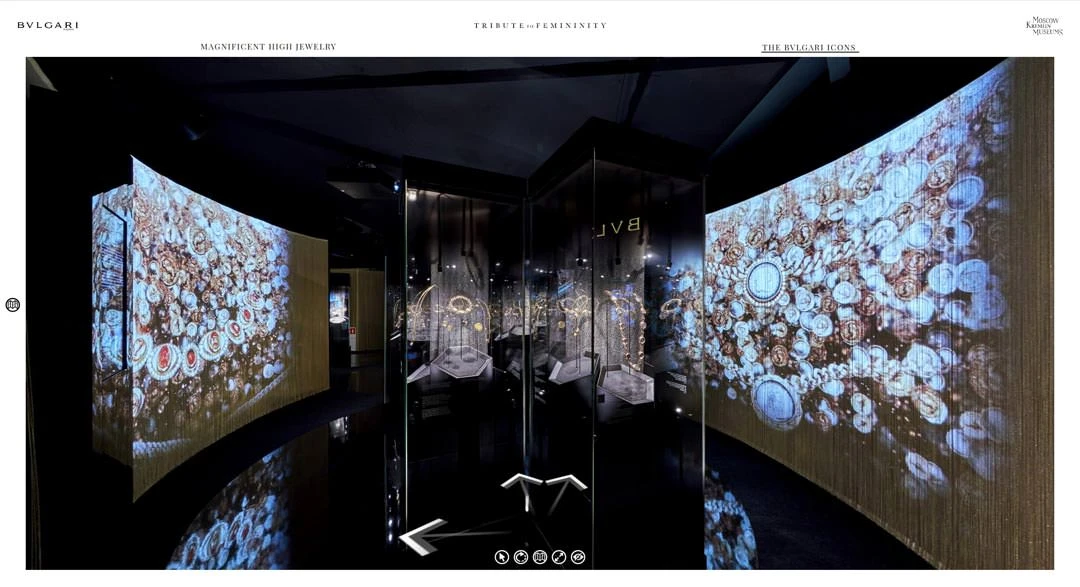 Virtual tour view of dimly lit gallery with illuminated coin-motif projections on large screens flanking glass vitrines