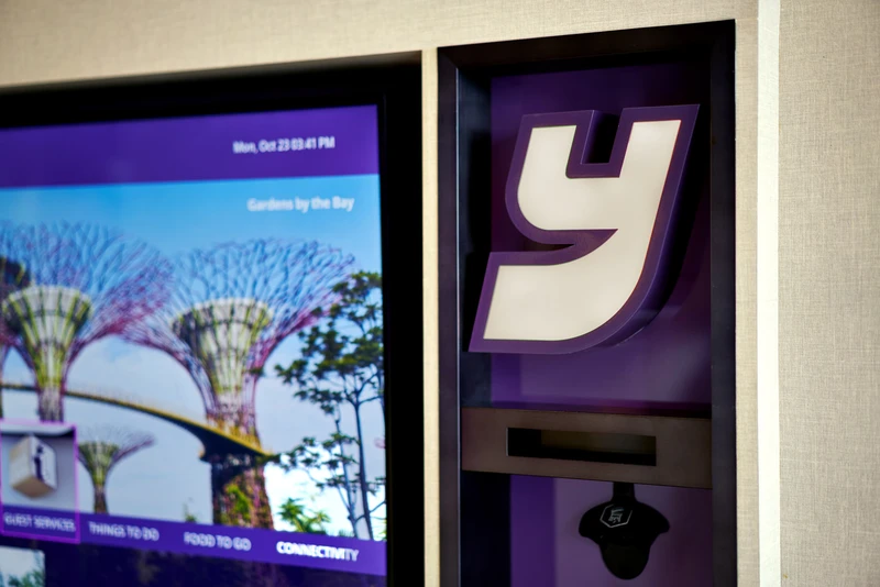 Self-service kiosk touchscreen with Gardens by the Bay and Y brand logo