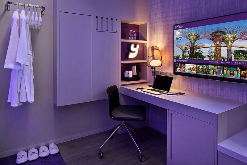 Wardrobe corner with robes, desk, laptop and branded Y accent light