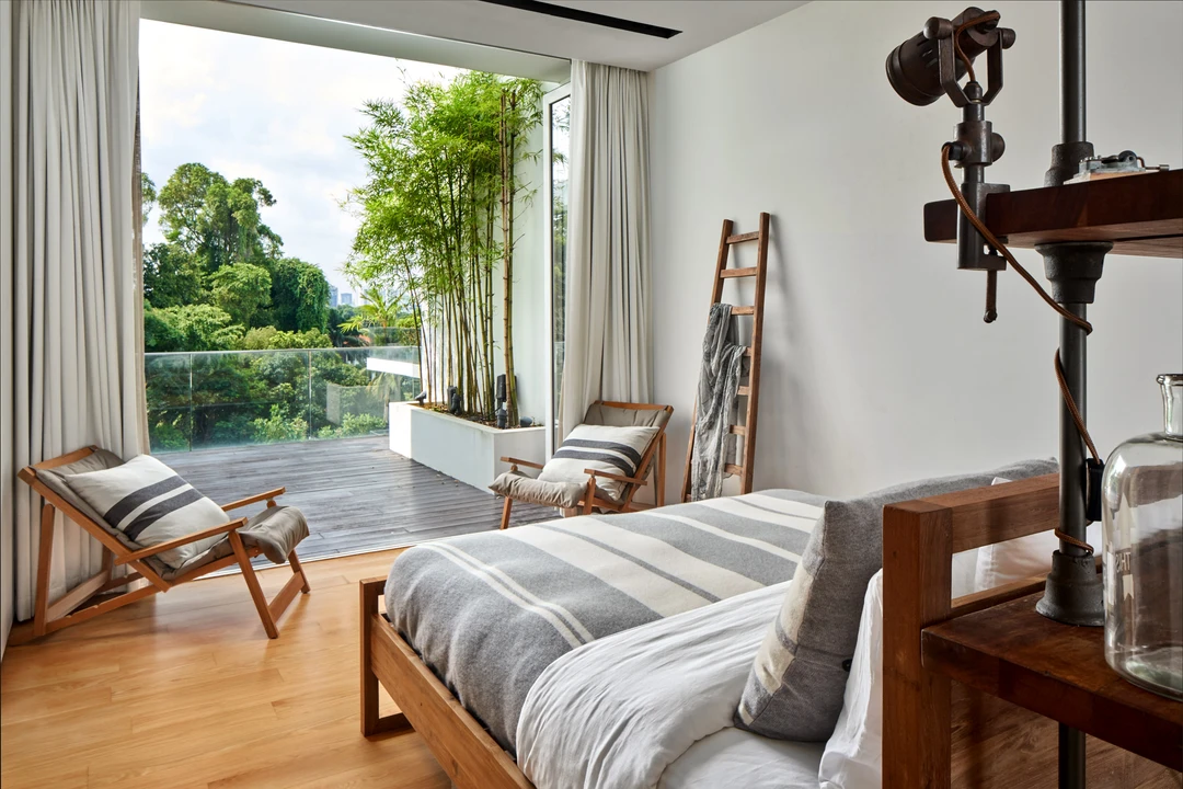 Bright bedroom with wooden bed and balcony access