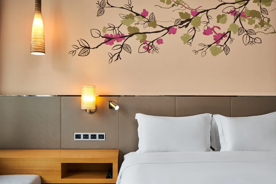 Headboard detail with bougainvillea mural and pendant lamp