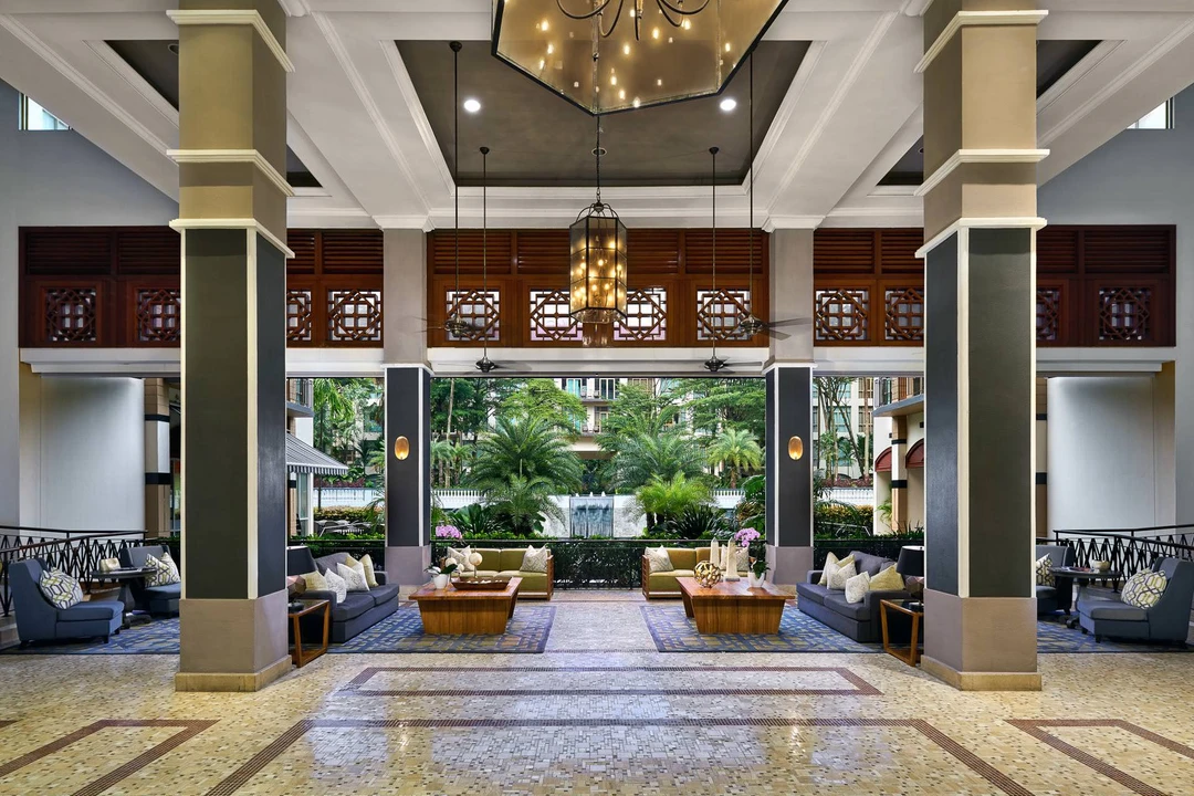 Colonial atrium lobby with lattice screens, lantern chandeliers and garden courtyard - Treetops Executive Residences Singapore hospitality photography