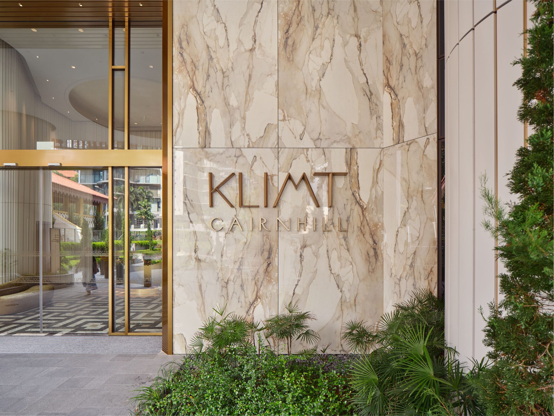 Klimt Cairnhill entrance with gold signage on Atlas Concorde marble-effect porcelain tile wall cladding