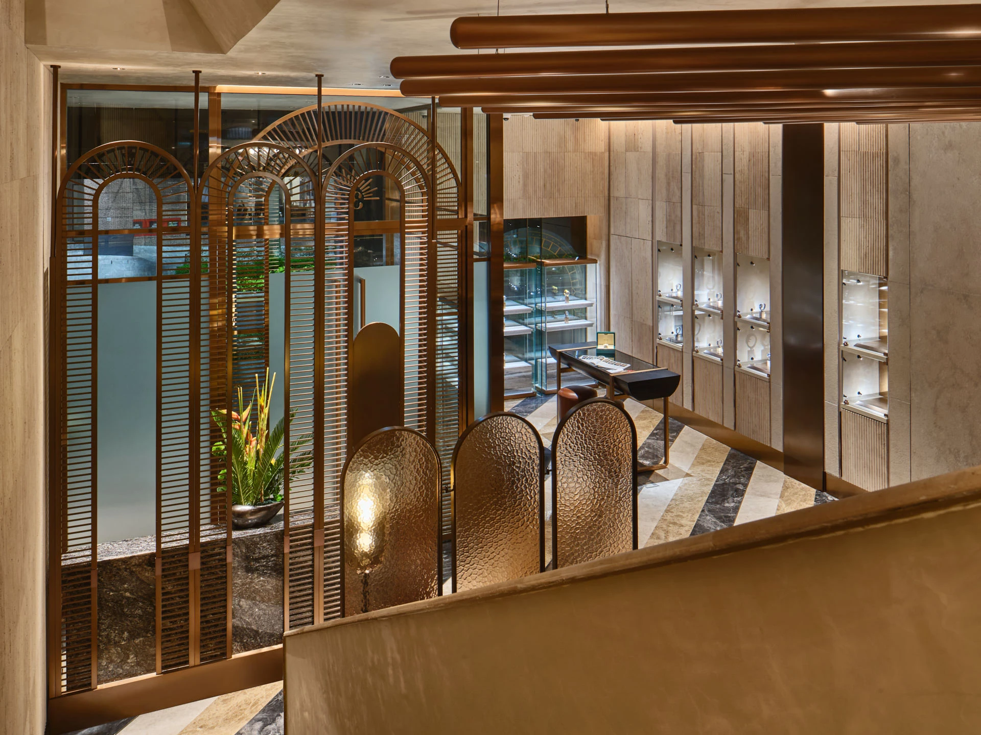 Showroom with brass partition, display cases and copper ceiling fixtures