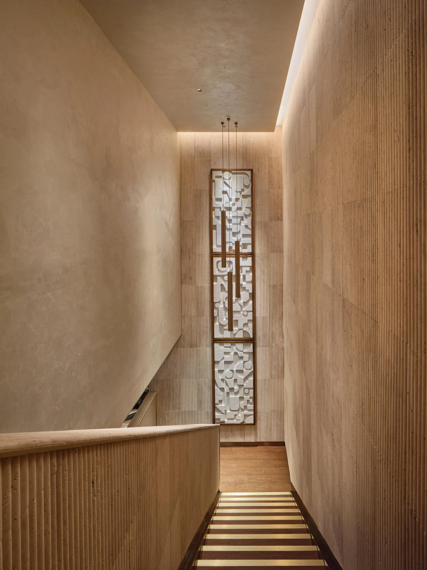Stairwell with fluted sandstone panels and geometric relief sculpture