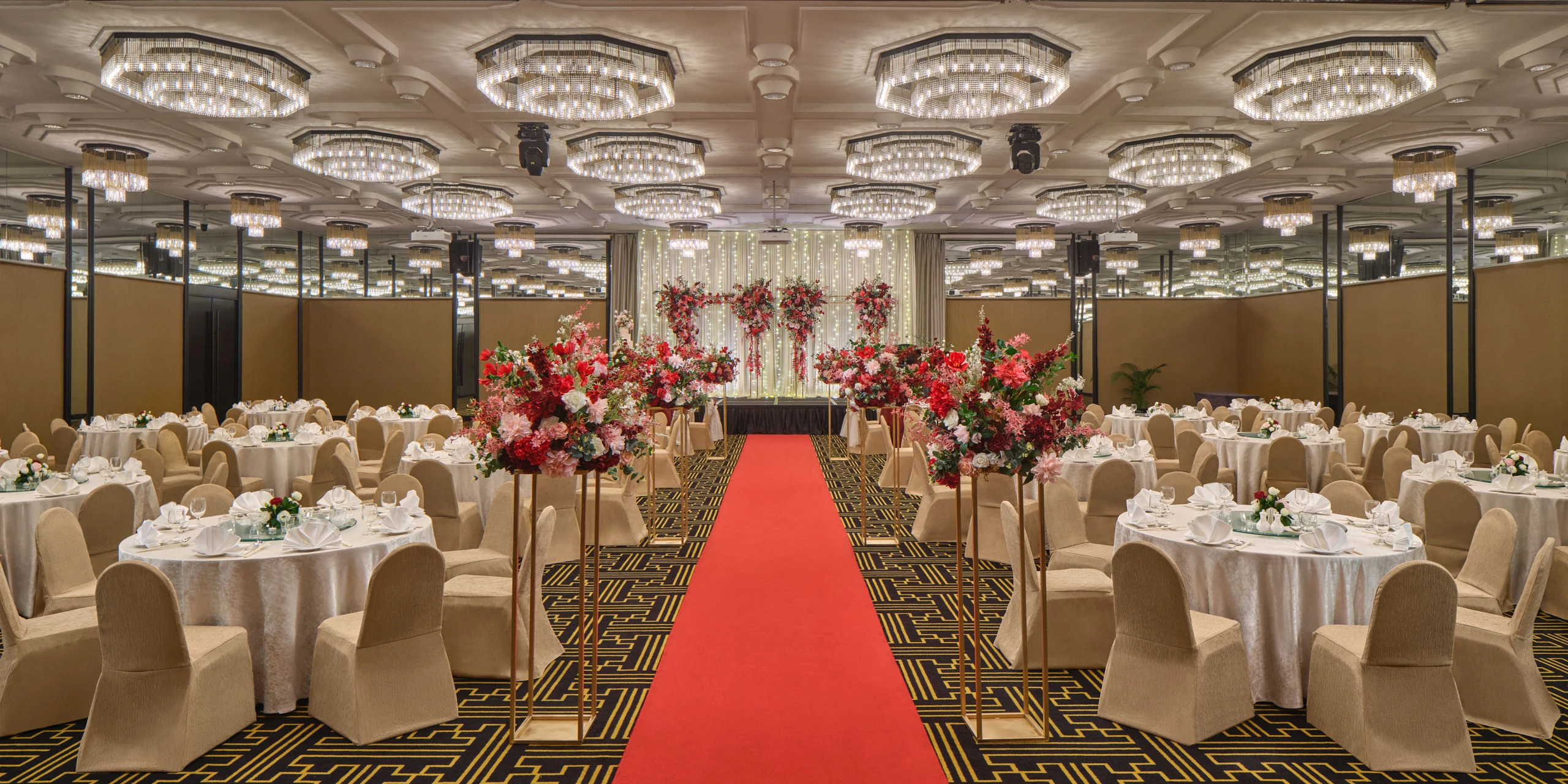 Scarlett wedding setup overview with red and gold linens and fairy-light backdrop