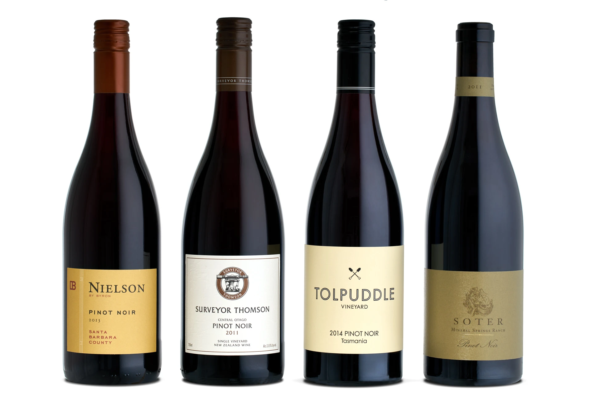 Four Pinot Noir bottles with backlighting revealing ruby wine