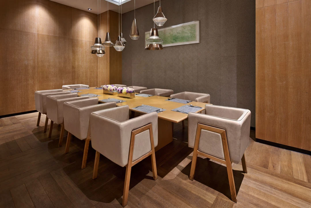 Private dining room with copper pendants and wood-panelled walls