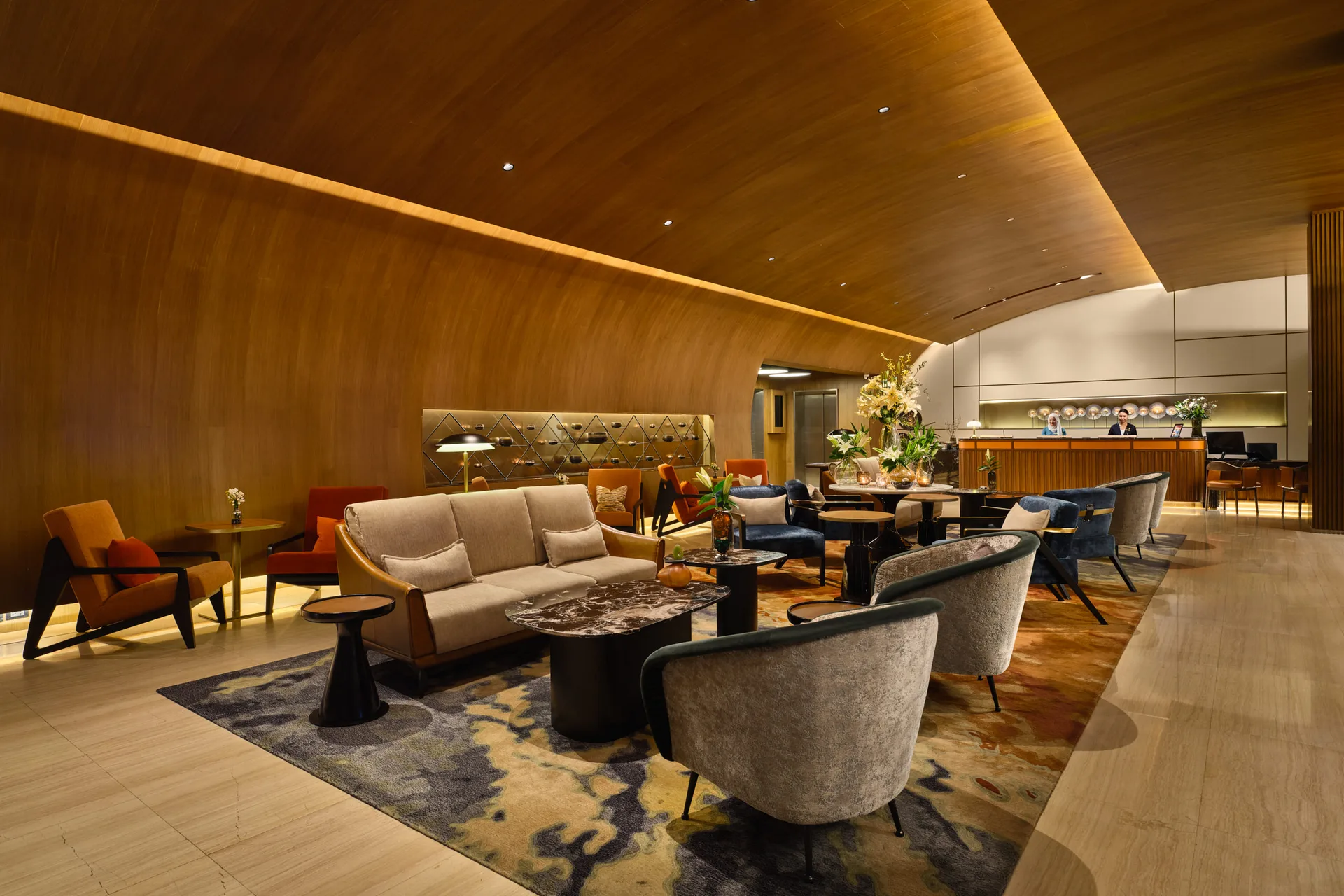 Fraser Suites Sukhumvit lobby seating area from the side with warm lounge furniture