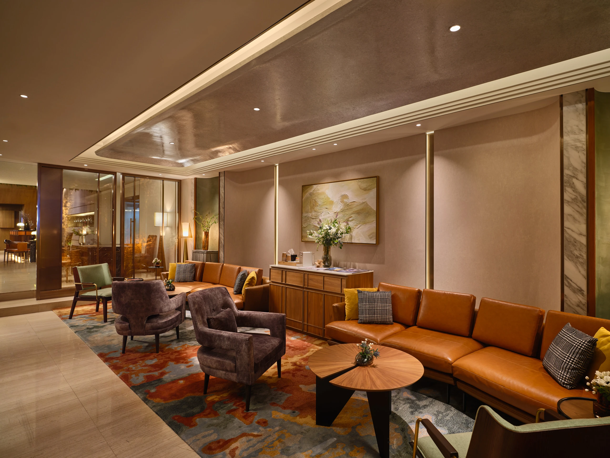 Fraser Suites Sukhumvit lounge with tan leather banquette and marble walls
