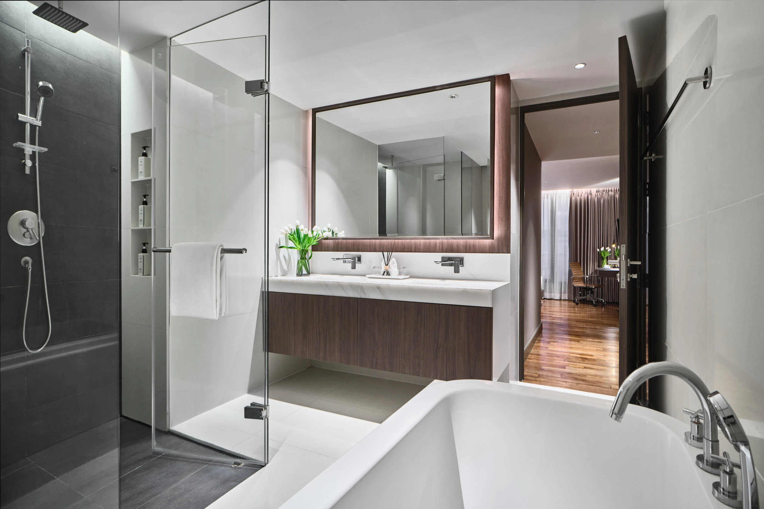 Bathroom with freestanding tub, rain shower and walnut double vanity