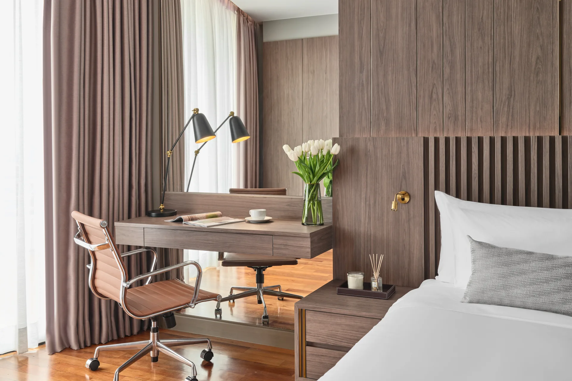 Work desk detail with Eames chair, tulips and brass reading light