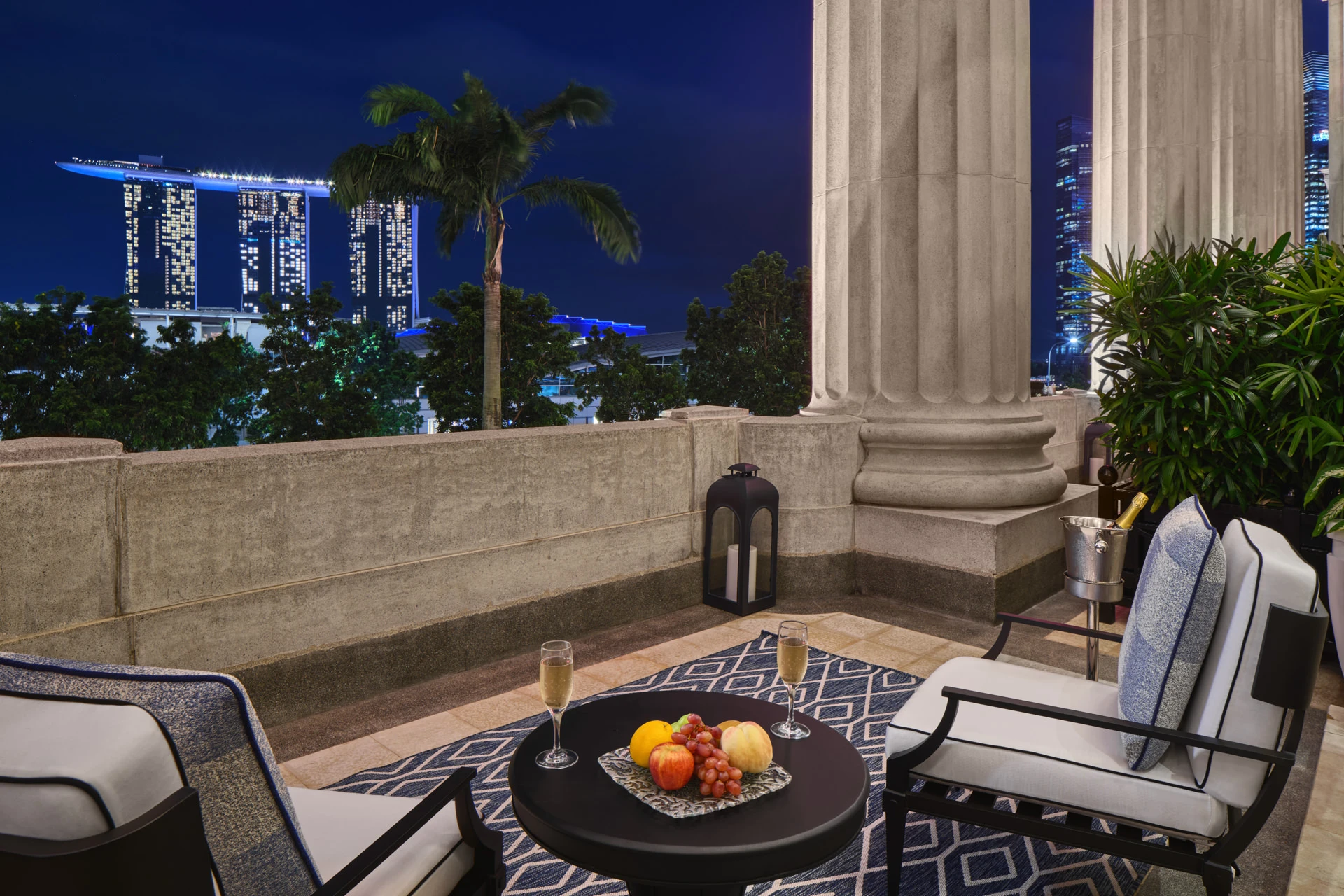 Terrace at dusk with champagne and Marina Bay Sands night view