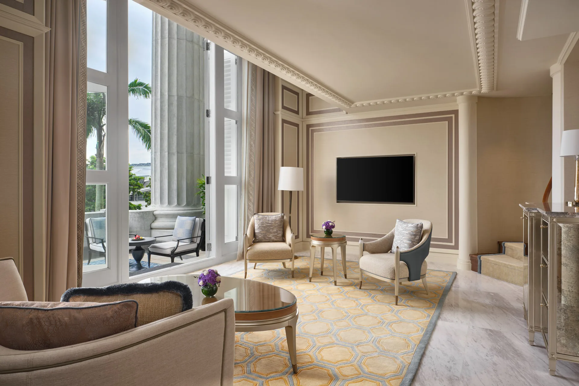 Living area with honeycomb rug, stone columns and French door daylight