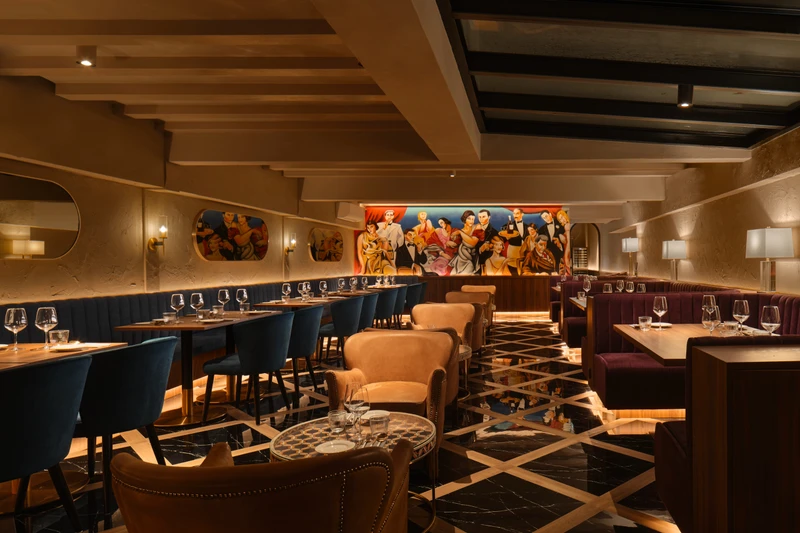 Gotti Singapore refined dining space with plush seating and bold mural focal point
