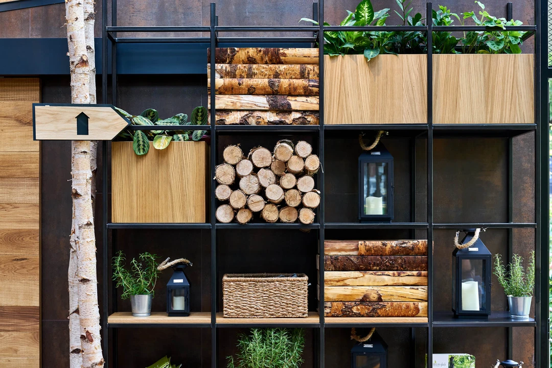 Detail restaurant photography showing custom shelving filled with decorative logs and plants, part of Hans Im Gluck’s WOLF-designed interior.