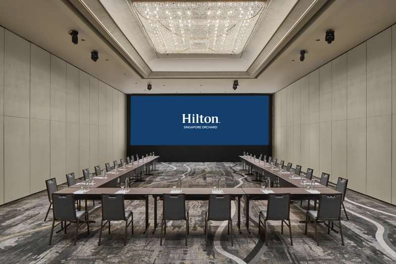 Hilton Singapore Orchard Ballroom 2 in U-shape setup with modern hotel meeting room seating and integrated presentation screens