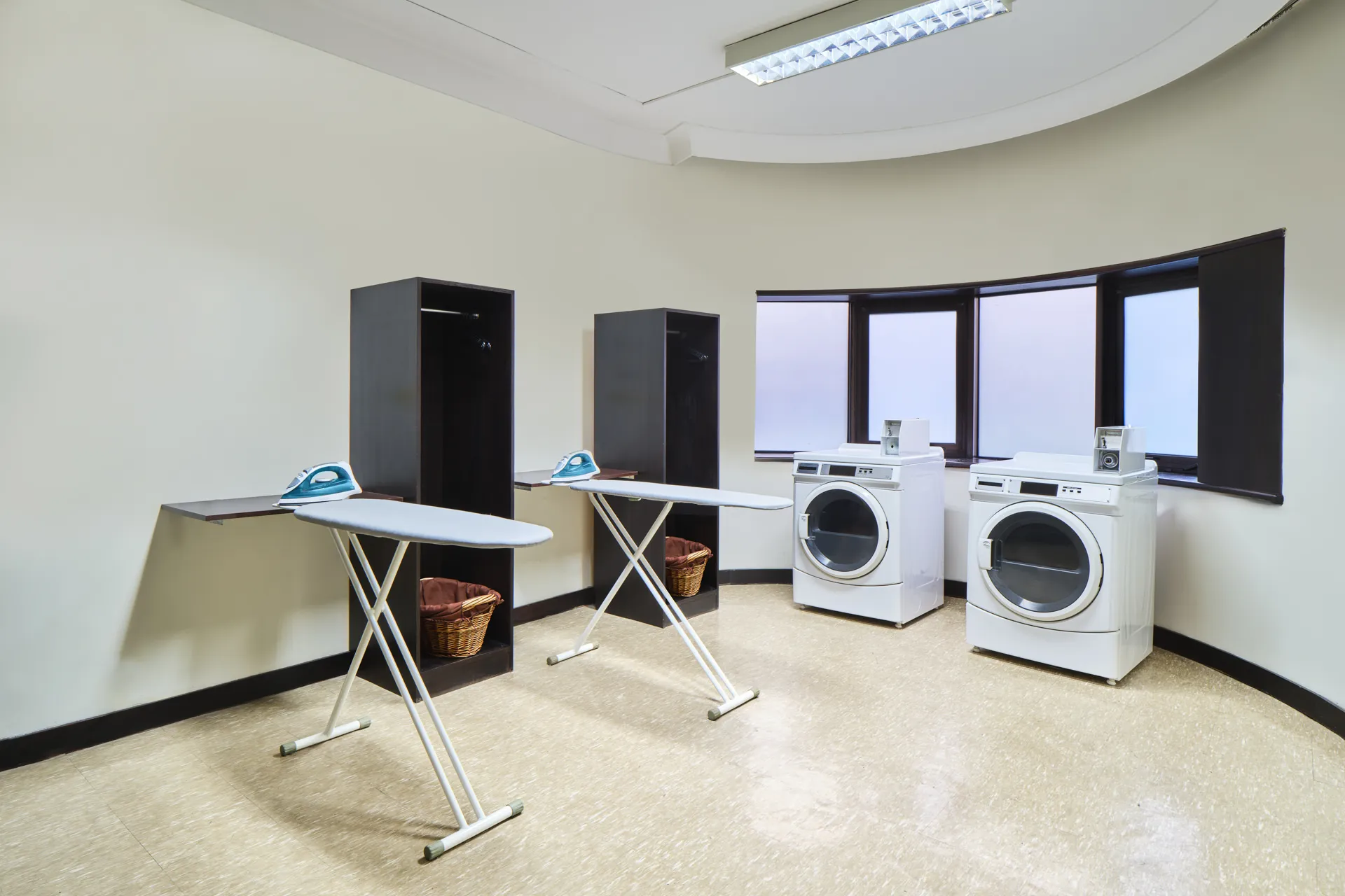 Self-service laundry with ironing boards, wardrobes and washer-dryers — Holiday Inn Atrium Singapore hotel photography