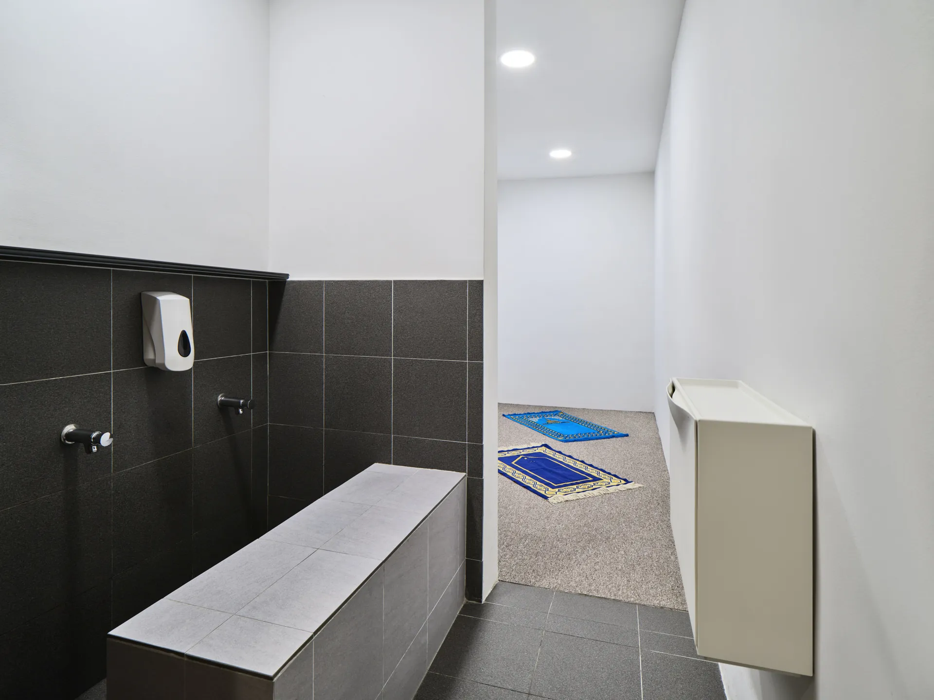 Prayer room with ablution area and blue prayer mats — Holiday Inn Atrium Singapore hotel photography