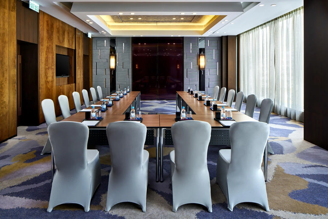 Boardroom with stone feature wall, gold cove ceiling and sheer drapes — Crowne Plaza Hong Kong function room photography