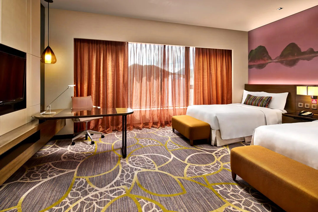 Twin room with pink mountain mural, mustard ottomans and pendant light — Crowne Plaza Hong Kong hotel photography