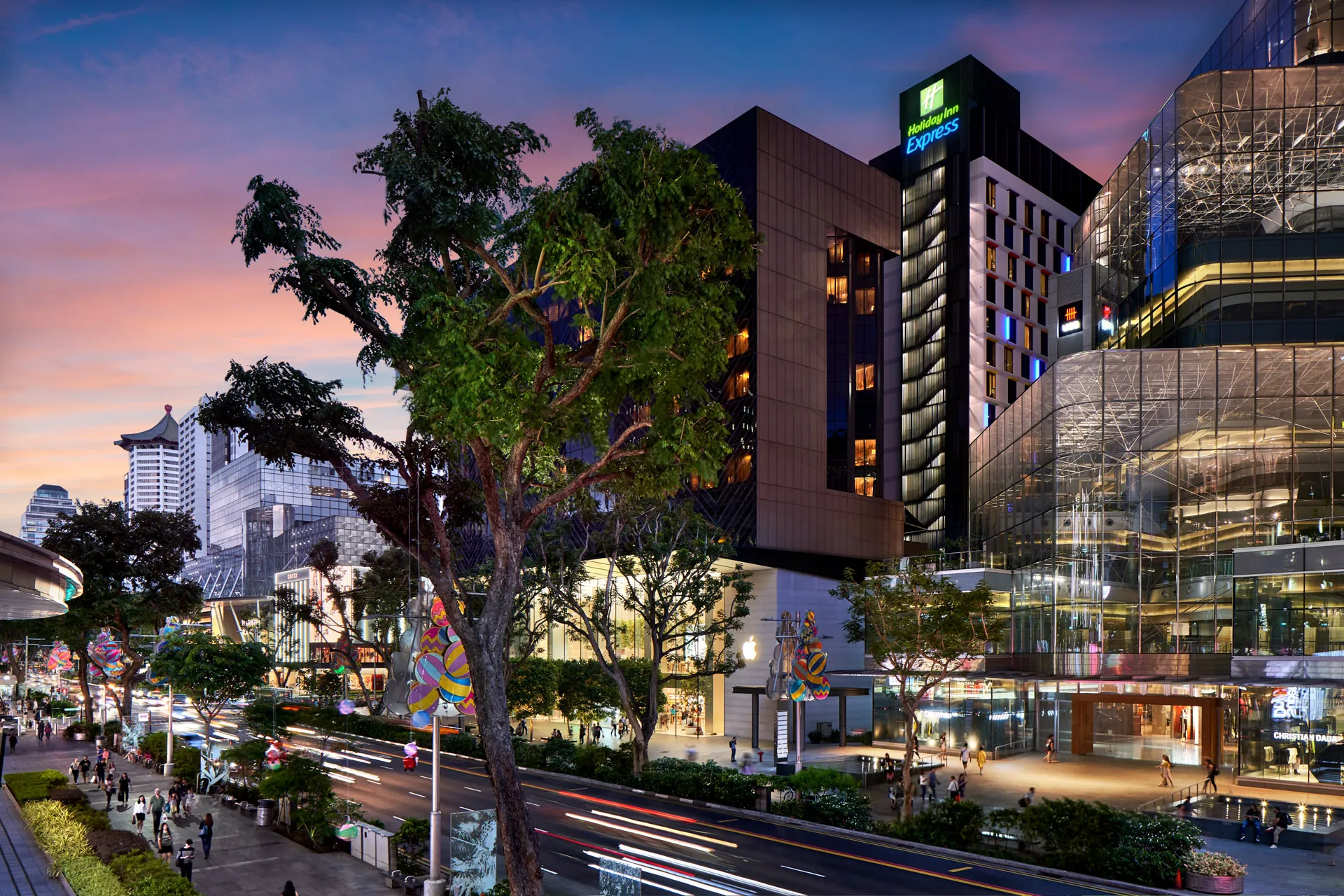 Hotel tower at sunset with car light trails along Orchard Road — Holiday Inn Express Singapore architectural photography