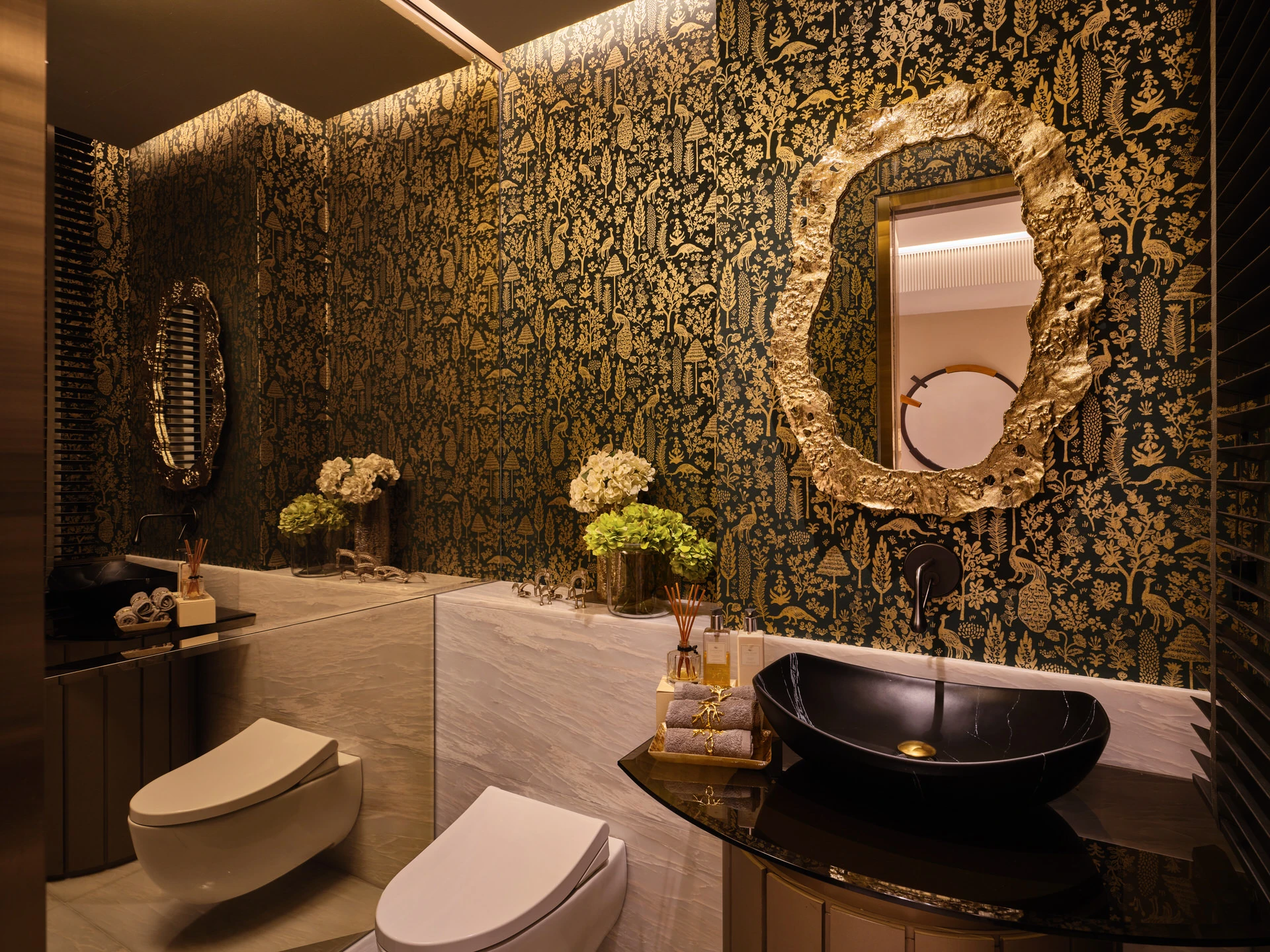 Powder room with teal-gold botanical wallpaper and sculptural mirror
