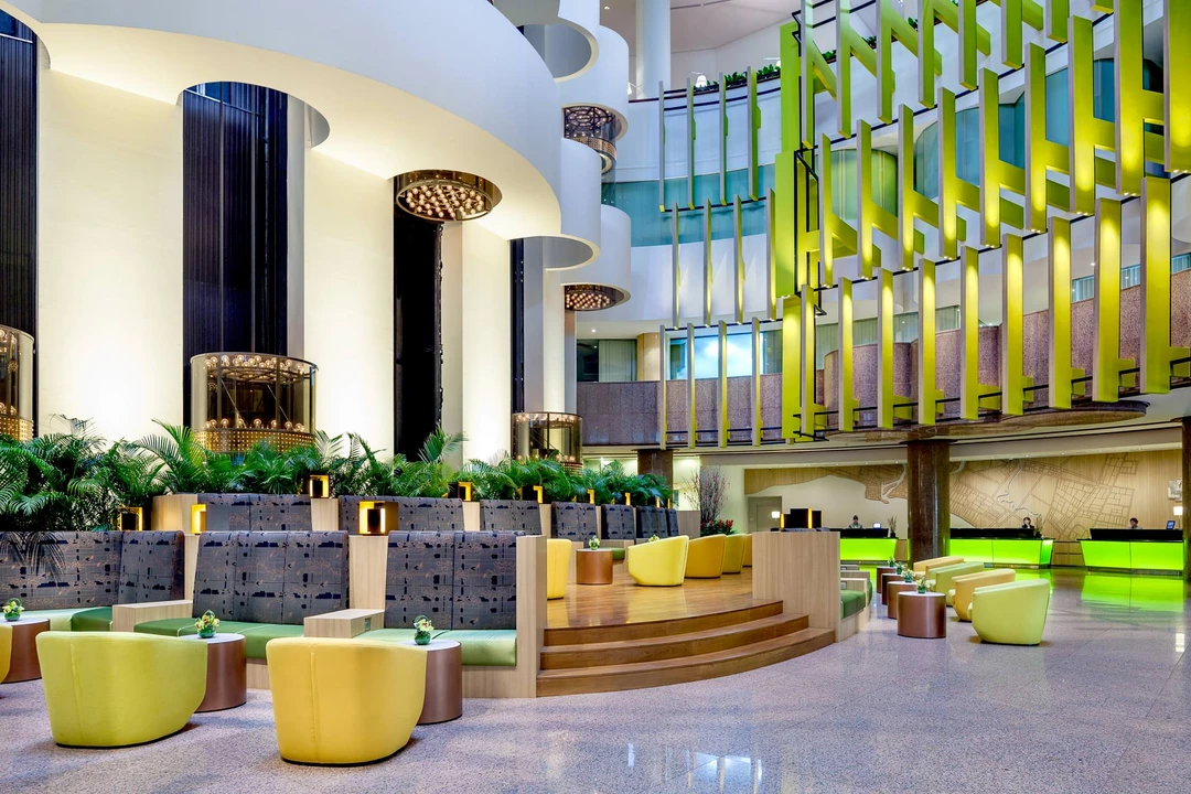 Contemporary lobby with lime-green lounge chairs and glass elevators