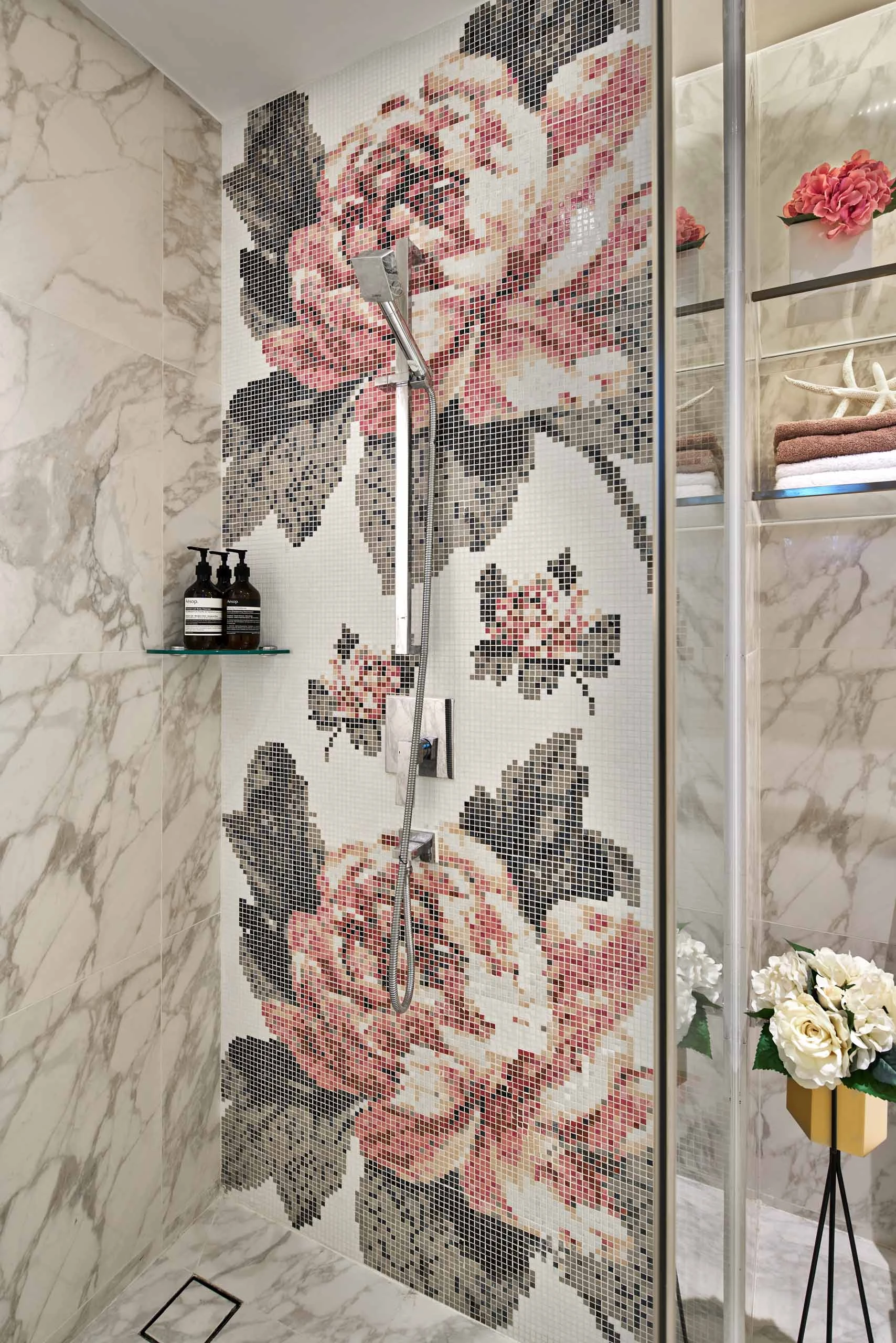 Luxury bathroom with floral feature wall and marble finishes