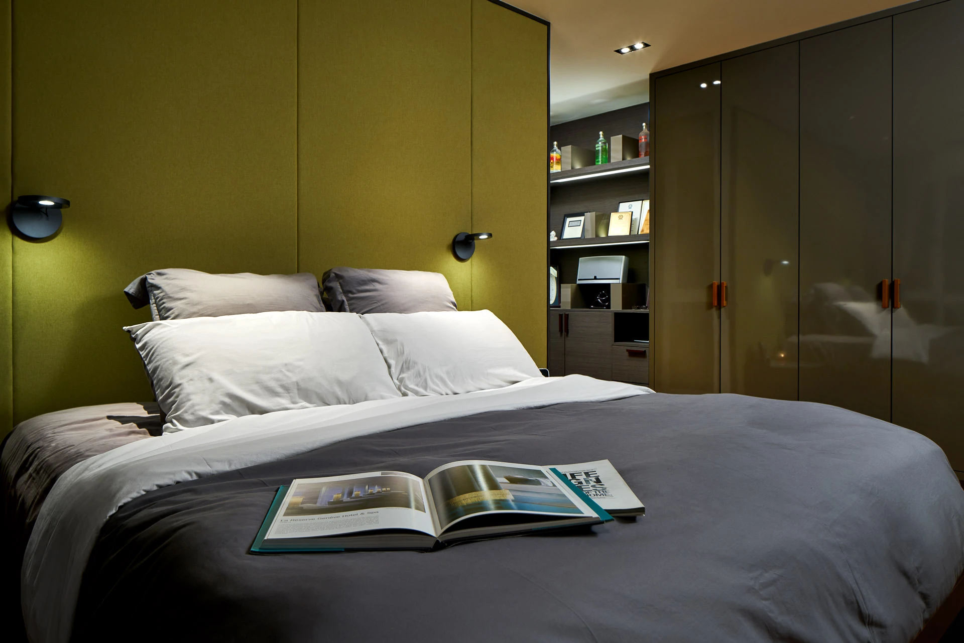 Master bedroom with olive-green headboard and illuminated display shelf — Simei Rise Singapore residential photography
