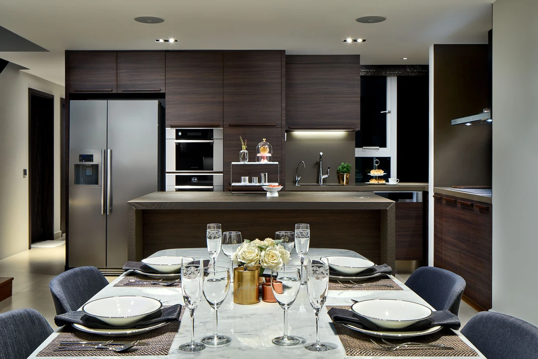 Kitchen with dark walnut cabinetry, waterfall island and marble dining — Simei Rise Singapore interior design photography