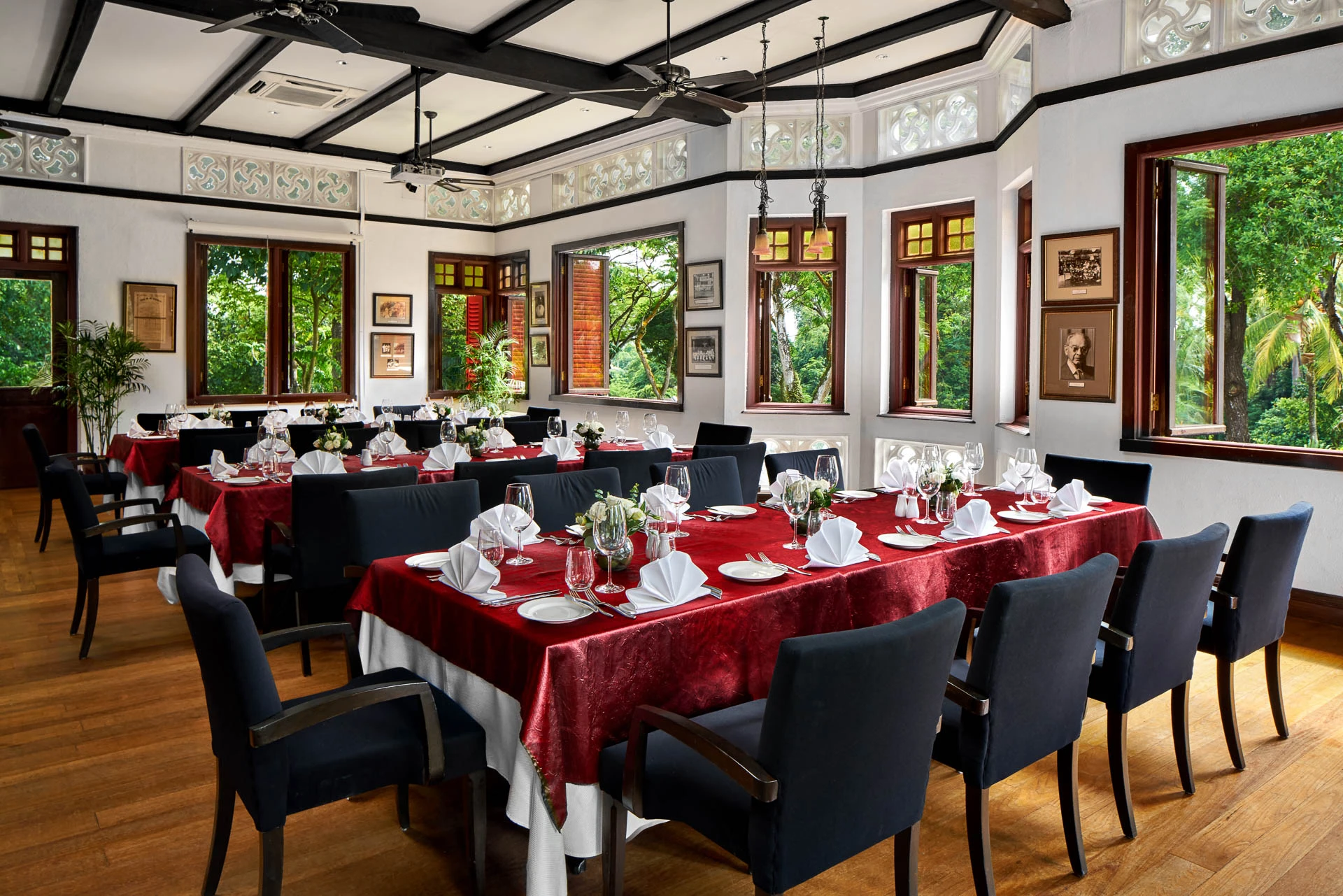 Rifle Lounge dining setup with crimson linens and coffered ceiling