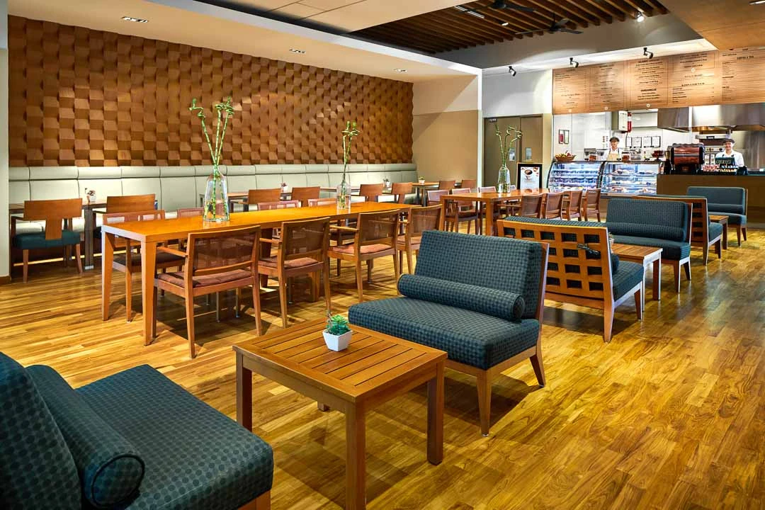 Tangles cafe with wooden block accent wall and teal settees