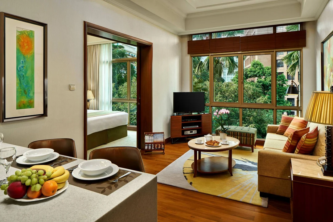 One-bedroom suite living area with striped sofa and dining table - Treetops Singapore interior photography