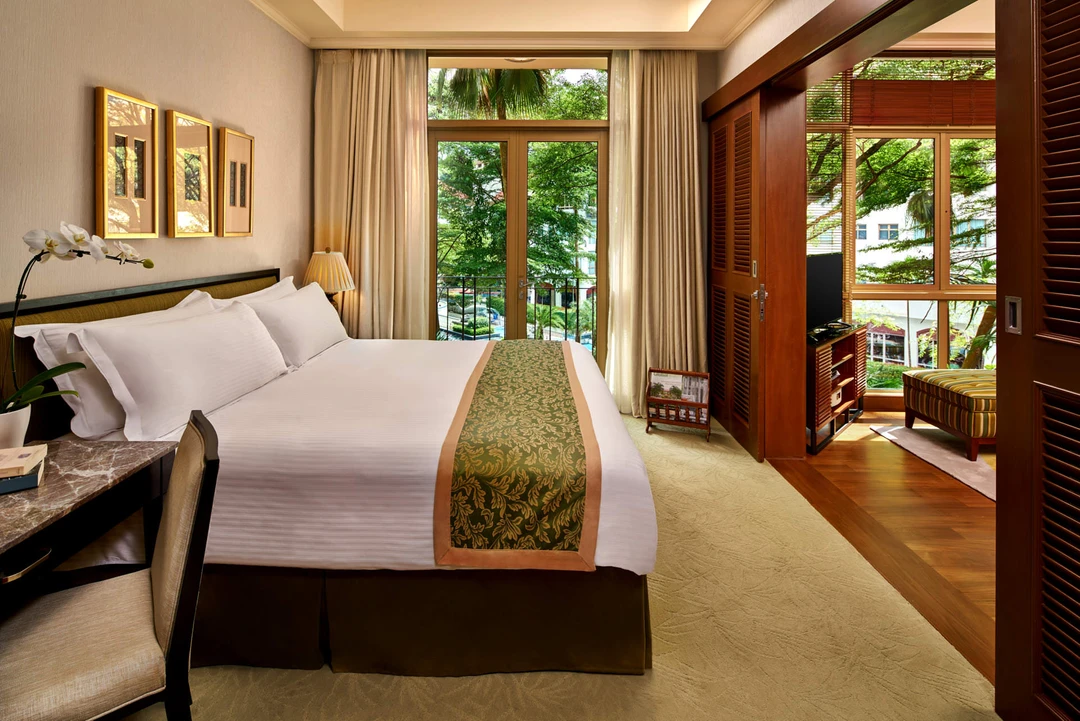 King bedroom with brocade runner, orchid and balcony French doors - Treetops Singapore interior photography