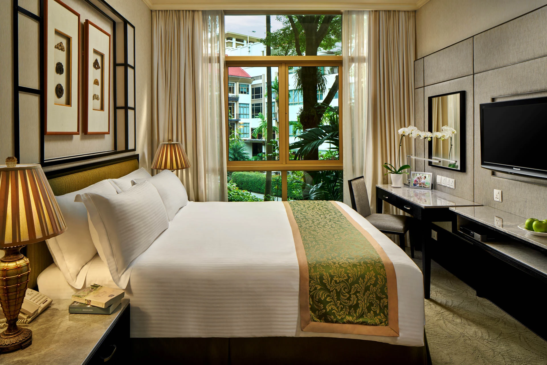 Master bedroom with brocade runner, desk and tropical garden view - Treetops Singapore interior photography