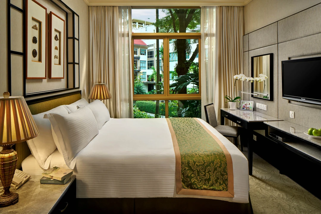 Master bedroom with brocade runner, desk and tropical garden view - Treetops Singapore interior photography