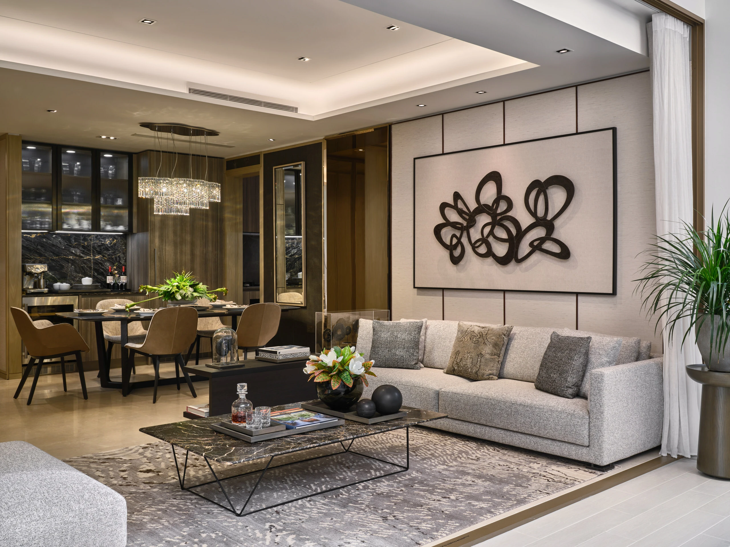 Open-plan living and dining area with kitchen in Klimt Cairnhill 3-bedroom showflat, featuring modern furniture and neutral tones