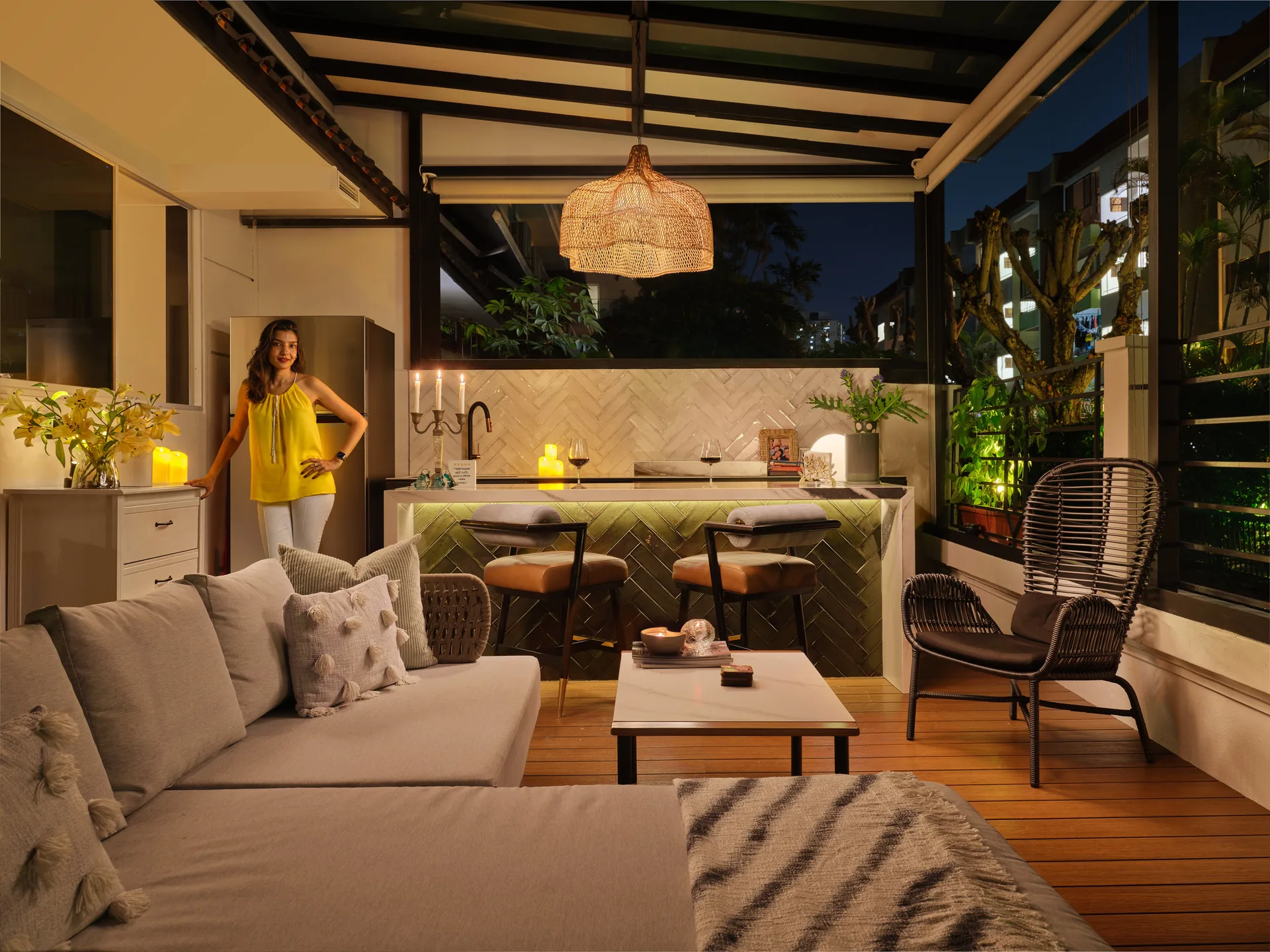 Outdoor bar with woven pendant lights, rattan stools and warm timber shelving