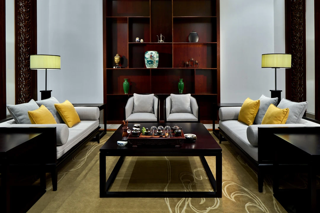 Private tea room with dark wood lattice screens and silk cushions — Crowne Plaza Ordos hotel photography