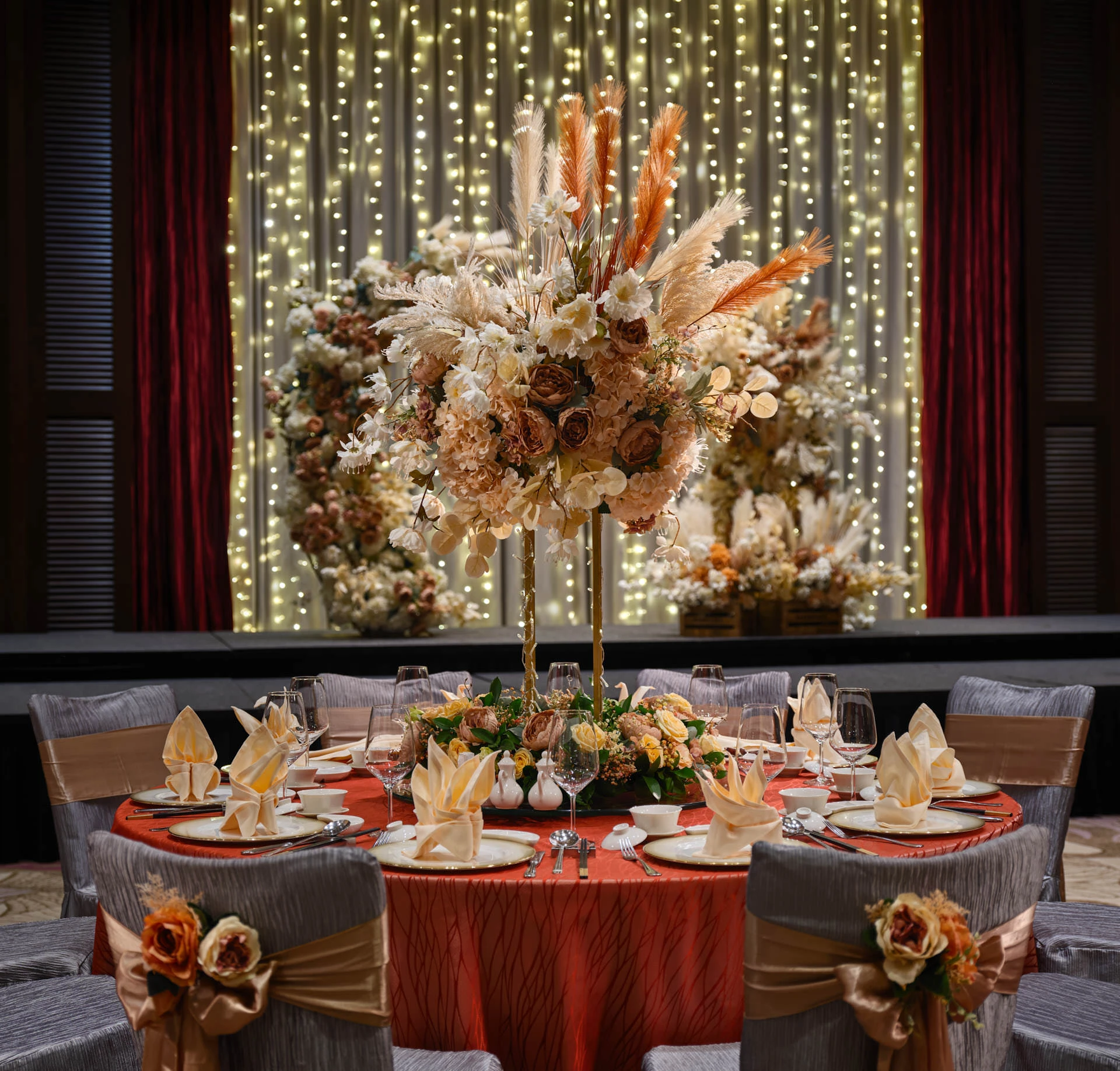 Paradox Singapore bohemian table setting with peonies, pampas grass, and gold charger plates