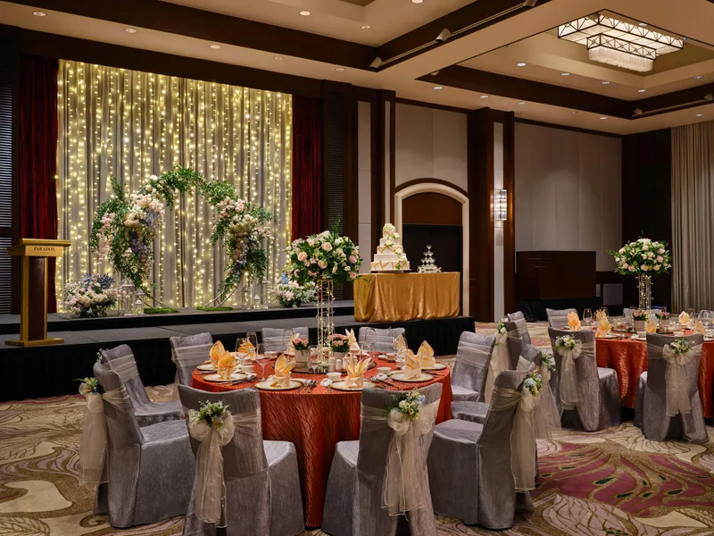 Paradox Singapore garden-inspired wedding setup with coral linens, organza bows, and pastel flowers