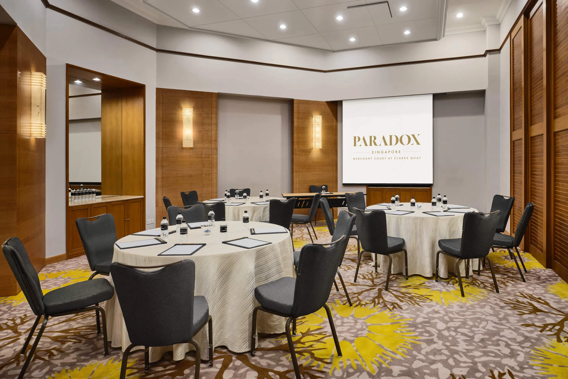 Paradox Singapore Maplewood Room workshop setup with tiered wall sconces and refreshment counter