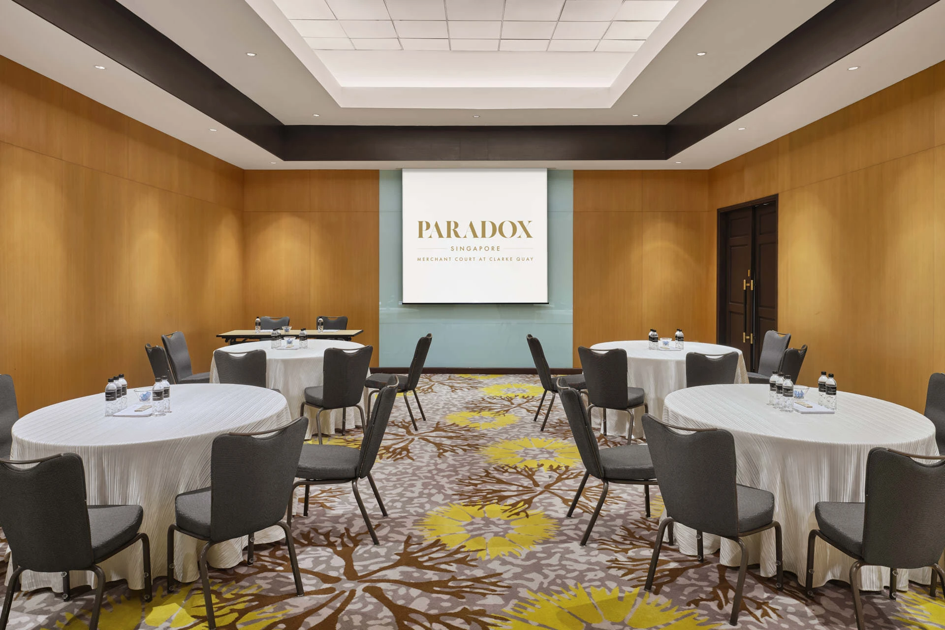 Paradox Singapore Oakwood Room crescent-round conference setup with blue accent wall