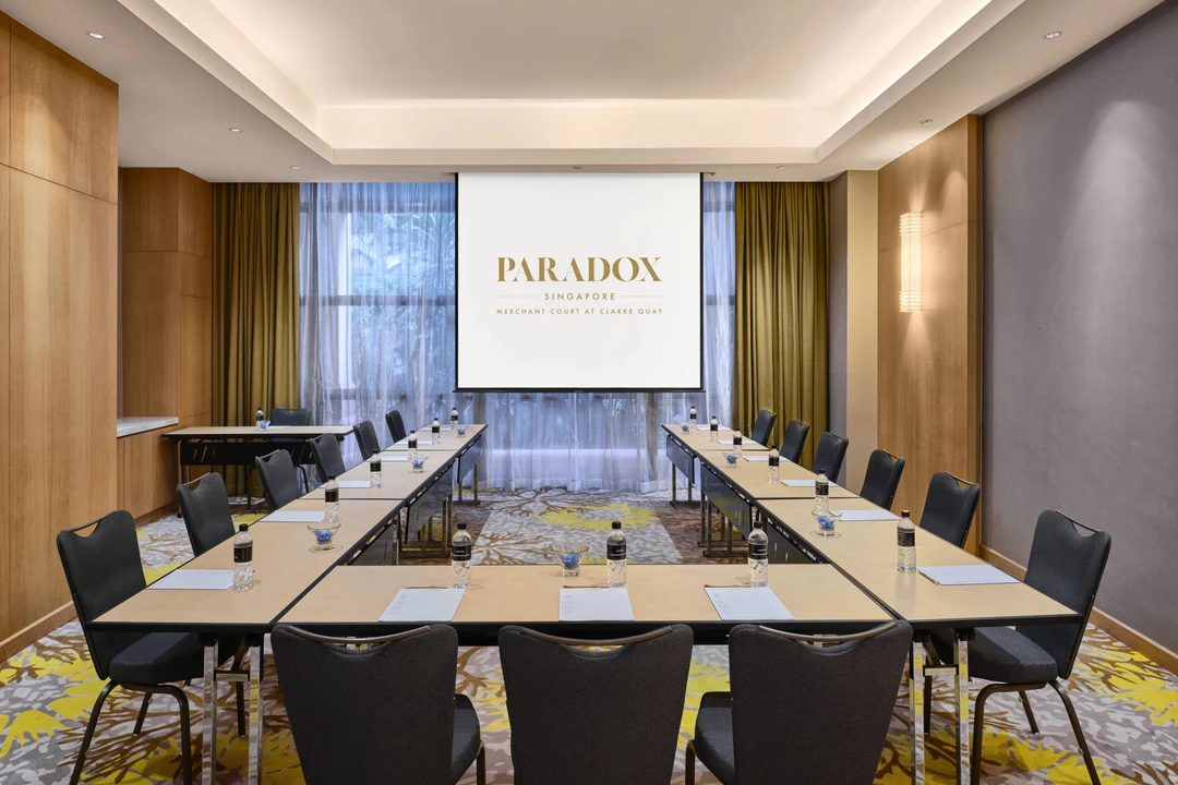 Paradox Singapore Oakwood Room in U-shape setup with natural light and olive curtains