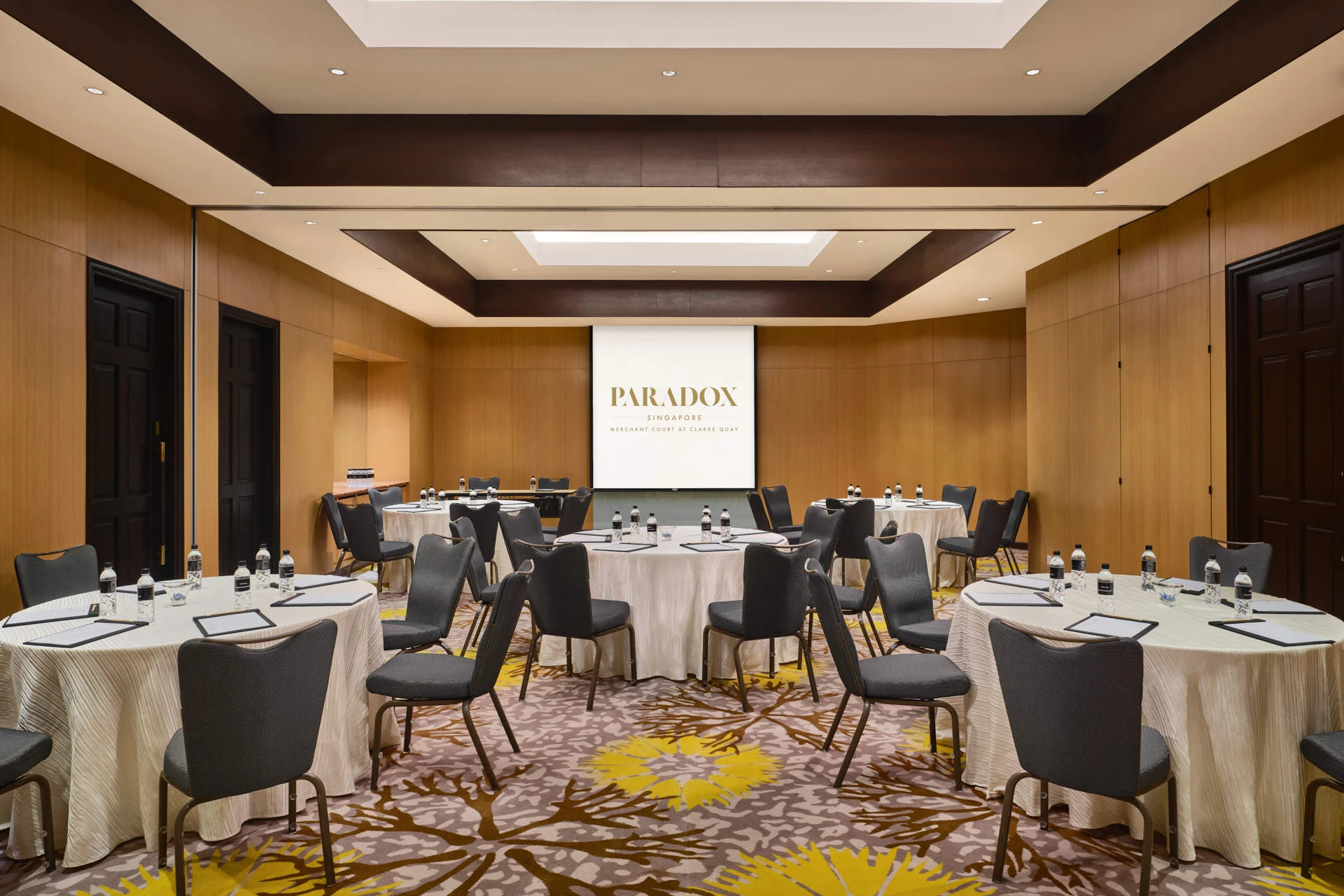 Paradox Singapore Rosewood Room cabaret setup with wood-panelled walls and coffered ceiling